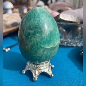 Polished amazonite egg on stand